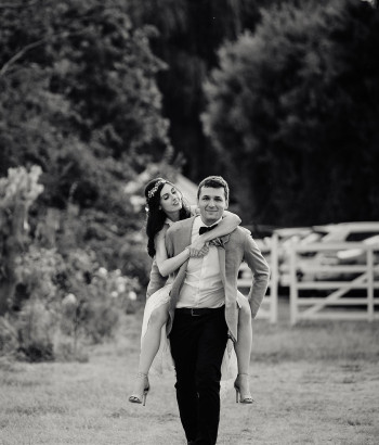 Bride and groom piggy back