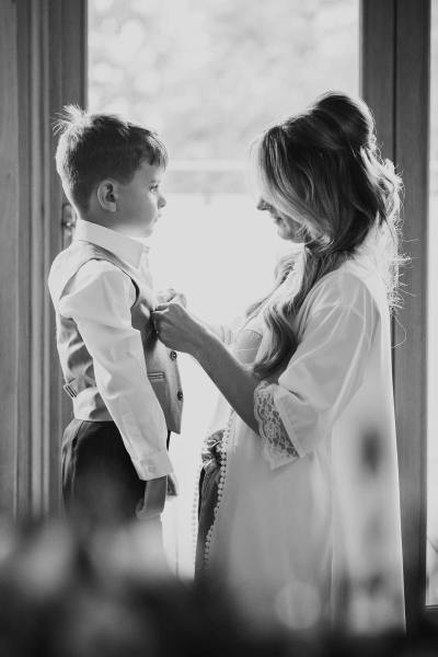 Bride getting son dressed