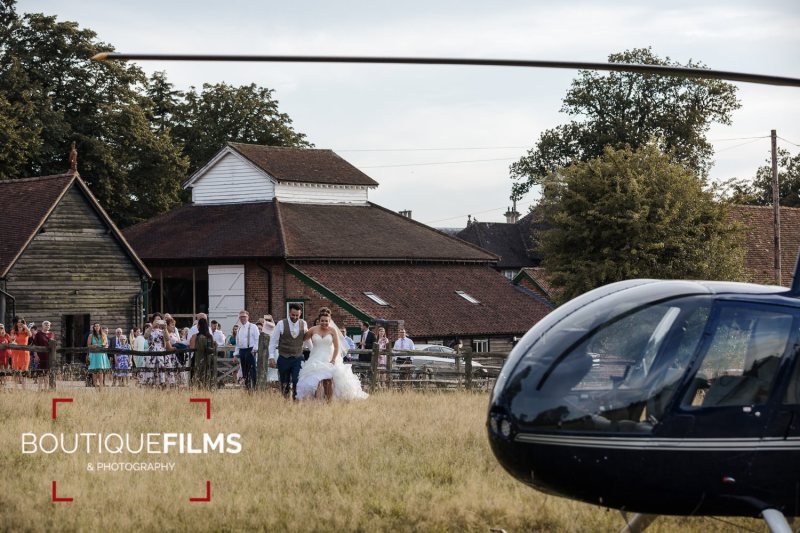 Bride and groom with helicopter - Gaynes Park wedding