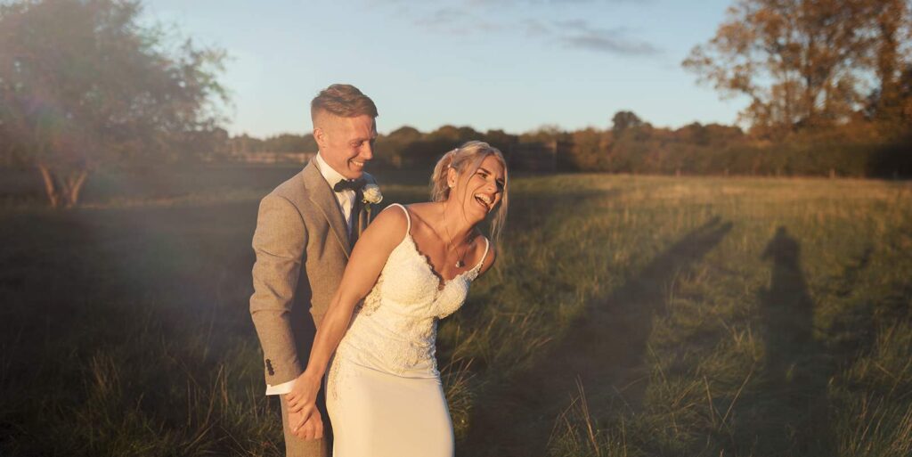 Professional Gaynes Park wedding photography; sunset wedding portraits Essex; candid bride and groom laughter; Scott Miller Experience golden hour.