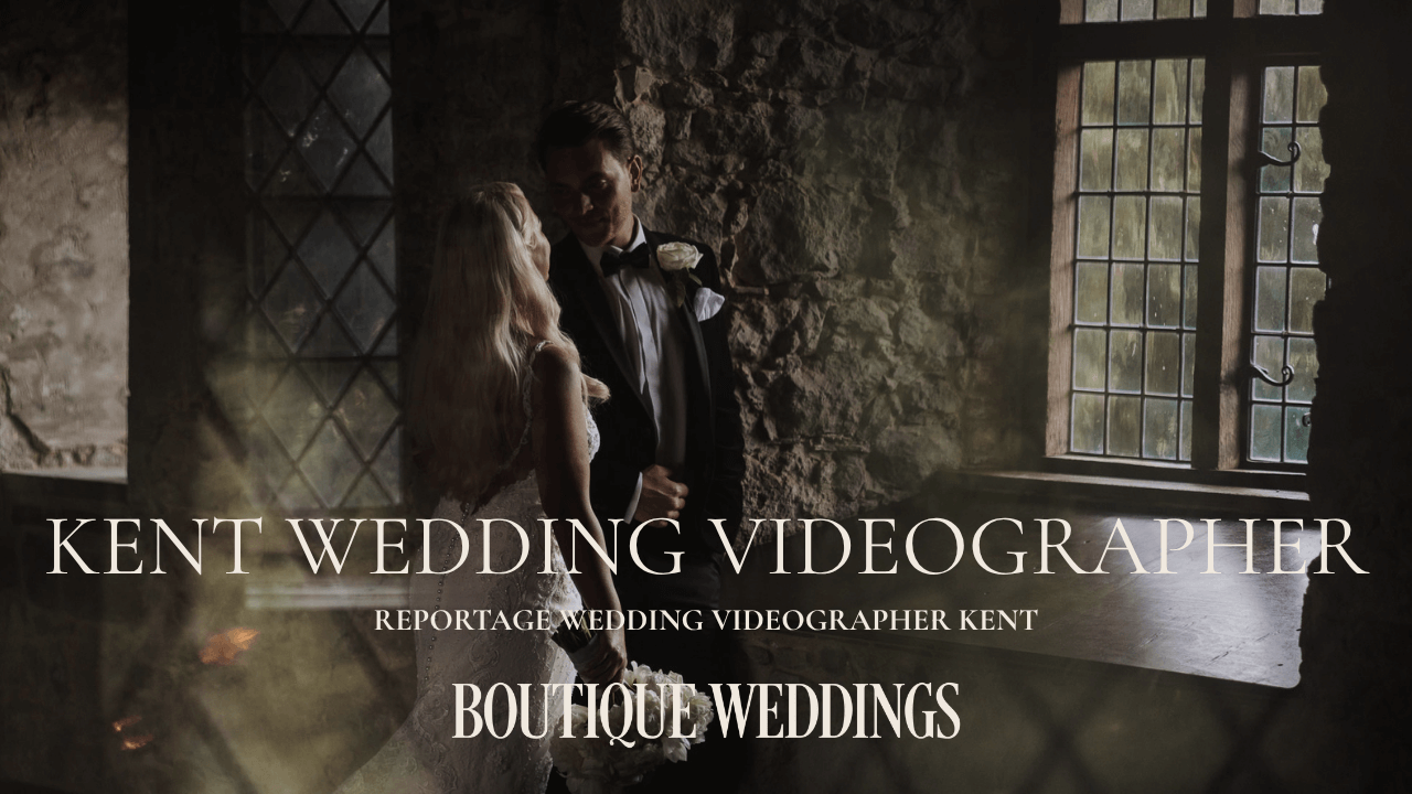 Cinematic winter wedding photography at Winters Barns Canterbury; bride and groom framed by atmospheric window light in the historic oak-beamed barn.