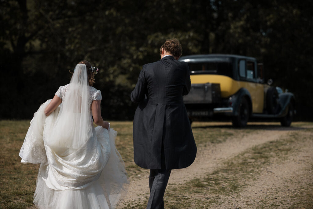 Bride and groom and vintage car in Colchester